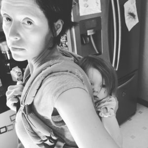 black and white photo of mom wearing baby in soft structured carrier