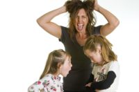 Mom pulling own hair and screaming while two young girls bicker