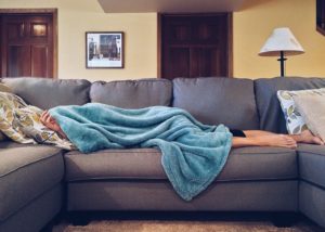 woman napping turquoise blanket